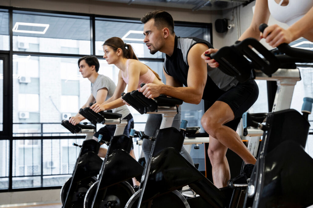 Indoor spin class at Rumble Fitness in Brockville with participants cycling in unison