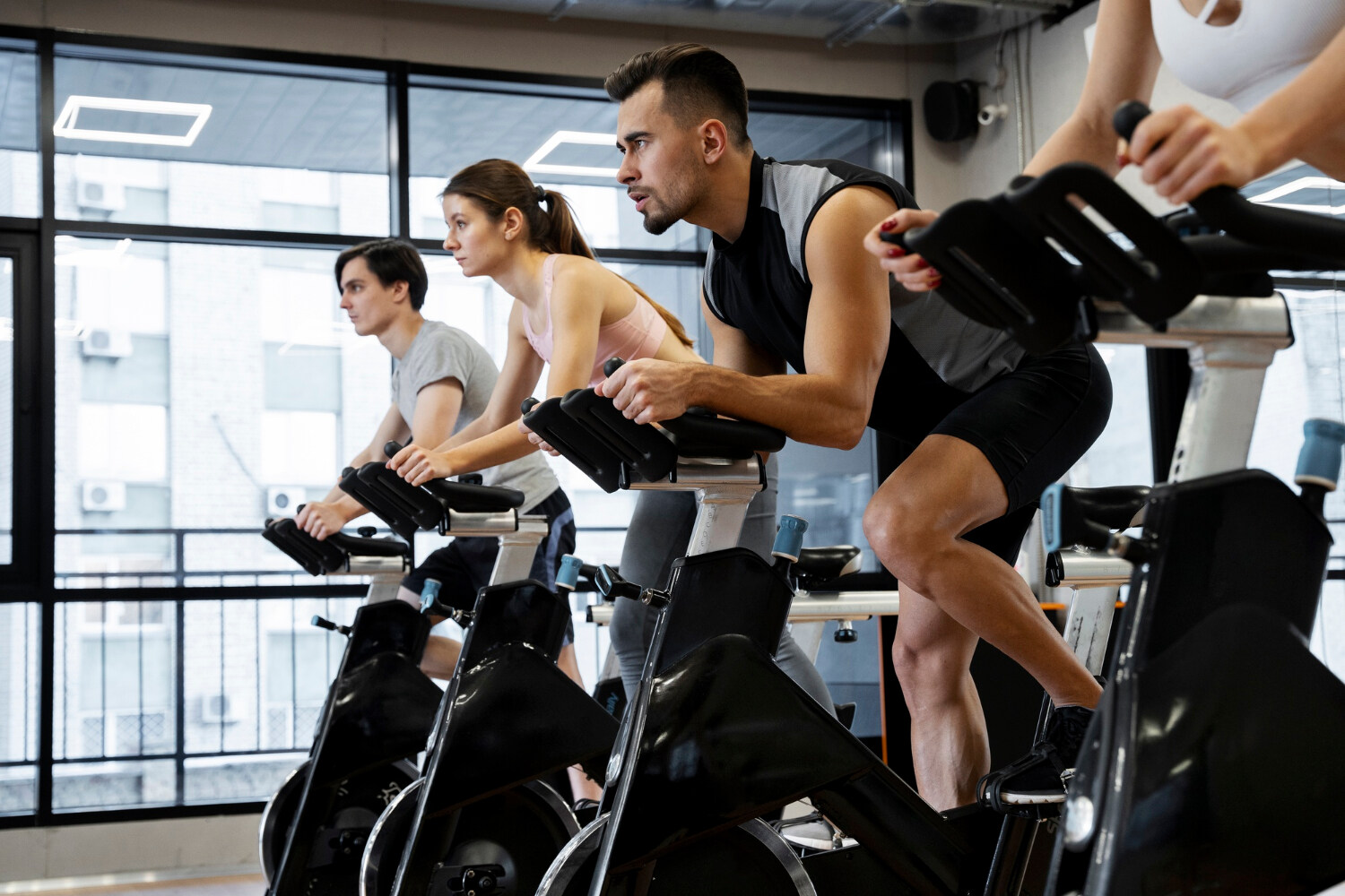 Indoor spin class at Rumble Fitness in Brockville with participants cycling in unison